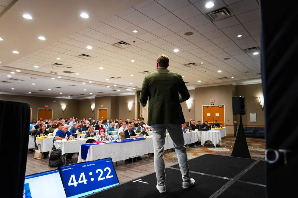 Jake Randolph presenting to an audience at AI Bot Summit